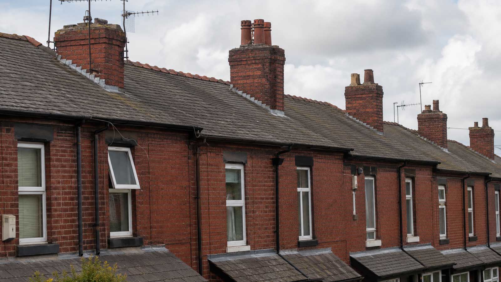 Victorian red-brick terraced houses with pitched roofs and chimney stacks